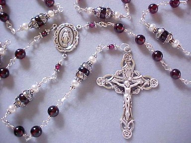 Handmade sterling silver wire wrapped rosary with genuine garnet gemstone and freshwater button pearls.