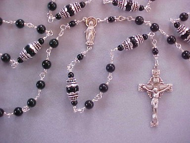 Sterling silver rosary with 6 & 8mmblack rainbowed obsidian, tulip caps, our lady figural center and starburst crucifix