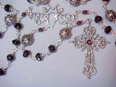rare museum quality rosary with garnet rondelles capped in Bali Silver, ornate filigree Bali Silver Our Fathers, Elaborate Renaissance design sterling silver cross with garnet stone and cherubs center, all sterling wire wrapped construction