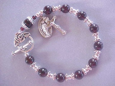 handmade rosary bracelet with genuine garnet gemstones, crucifix and medal dangles, rose toggle clasp